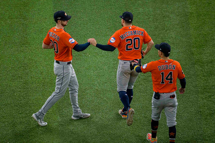 Oct 19, 2023; Arlington, Texas, USA; Houston Astros center fielder Mauricio Dubon (14) and left fielder Chas McCormick (20) and right fielder Kyle Tucker (30) celebrate the Astros victory over the Texas Rangers in game four of the ALCS for the 2023 MLB playoffs at Globe Life Field. Mandatory Credit: Jerome Miron-USA TODAY Sports